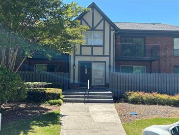 Charming two-story townhome with a manicured front yard and welcoming entrance at 6851 Roswell Rd # O10, Atlanta, GA 30328