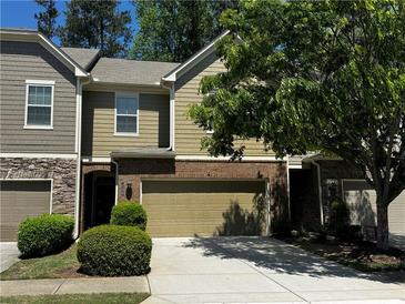 Charming townhome with a two-car garage and tasteful brick and siding accents at 1598 Lenox Overlook Ne Rd, Atlanta, GA 30329