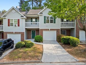 Charming townhome with brick accents, a one-car garage, and a well-maintained landscaped front yard at 4643 Grand Central Pkwy, Decatur, GA 30035