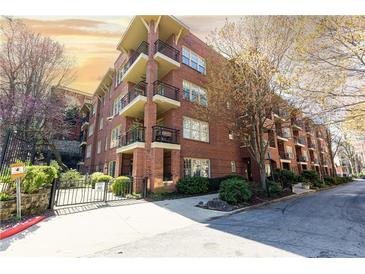 Charming brick condo building with multiple balconies and a well-maintained garden entrance in a desirable neighborhood at 273 12Th Ne St # 114, Atlanta, GA 30309
