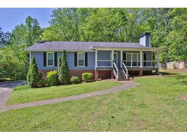 Charming single-story home featuring a welcoming front porch and well-manicured lawn at 3090 Thrasher Nw Ct, Kennesaw, GA 30144