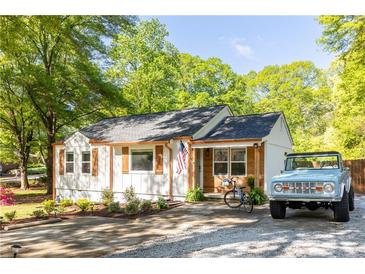 Charming single story home with white siding, wood trim, and a well maintained front yard at 2086 Harold Se Ave, Smyrna, GA 30080