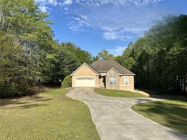 Charming single-story home with a stone accent, a two-car garage, and a welcoming curved driveway at 4383 Post Rd, Winston, GA 30187