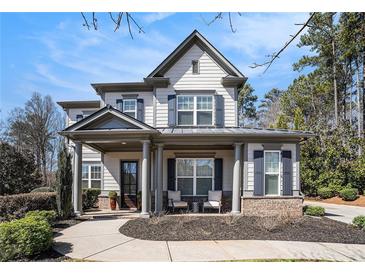 Charming two-story home featuring a welcoming front porch, well-manicured landscaping, and inviting curb appeal at 2005 Etris Manor Dr, Roswell, GA 30075