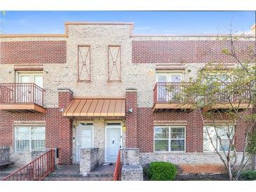 Charming brick townhome with cozy balcony and well-maintained landscaping, offering an inviting curb appeal at 432 Ira Sw St # 201, Atlanta, GA 30312