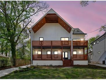 Stunning two-story home featuring a modern design, wooden balconies, and a meticulously manicured lawn at 1882 Francis Nw Ave, Atlanta, GA 30318