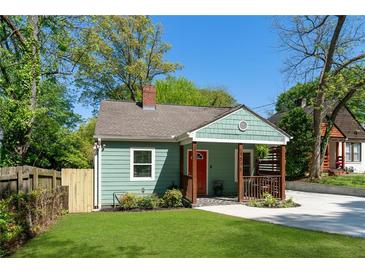 Charming renovated bungalow with a cozy front porch, freshly painted exterior, and lush green lawn at 1518 Langston Sw Ave, Atlanta, GA 30310