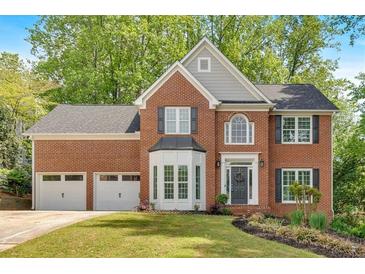 Beautiful brick home features a two-car garage and manicured lawn at 4380 Laurian Nw Dr, Kennesaw, GA 30144