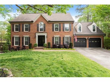 Beautiful brick two-story home with mature landscaping and attached two car garage at 4813 Fernie Ne Ct, Marietta, GA 30068