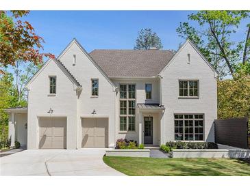 Beautiful white brick home with two-car garage and professionally landscaped front yard and walkway at 3290 Dunlop Ne Ct, Atlanta, GA 30319