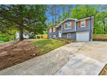 Inviting home with gray siding, shutters, white trim, and an attached garage at 2663 Lowell Dr, Morrow, GA 30260