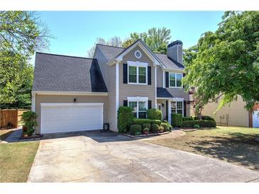 Charming two-story home boasts a well-manicured lawn and a two-car garage at 5221 Huntcrest Sw Pl, Mableton, GA 30126