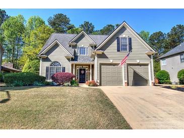 Charming two-story home with a well-manicured lawn and two-car garage at 192 Adelaide Xing, Acworth, GA 30101