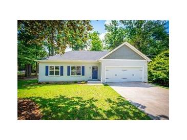 Charming one-story home with a two-car garage, well-manicured lawn, and blue shutters at 4694 E Glen Ridge E Cir, Winston, GA 30187