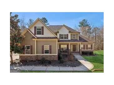 Charming two-story home with a well-maintained front yard and welcoming porch at 283 Rosebay Ln, Sharpsburg, GA 30277