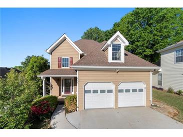 Charming two-story home with attached two car garage and well-maintained landscaping at 877 Ashwood Walk, Decatur, GA 30030
