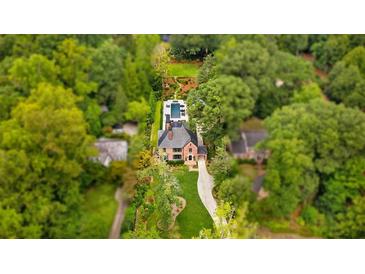 Stunning aerial view of estate home with lush landscaping and backyard pool at 808 Lullwater Ne Rd, Atlanta, GA 30307