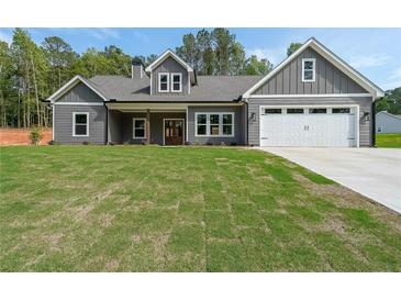Charming craftsman-style home with gray siding, a manicured lawn, and an attached two-car garage at 82 Lexie Court, Rockmart, GA 30153