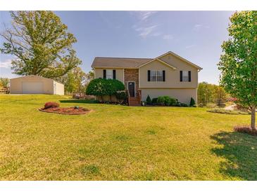 Charming home with a manicured lawn and a detached garage on a sunny day at 15 Cobblestone Ct, Douglasville, GA 30134
