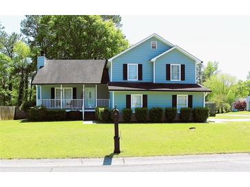Charming two-story home with a well-manicured lawn and inviting front porch at 3420 Caley Mill Ln, Powder Springs, GA 30127