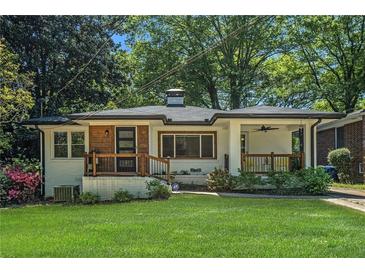 Charming home boasts a lush front yard and quaint porch, perfect for relaxing outdoors at 1424 Adele Sw Ave, Atlanta, GA 30314