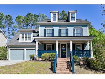 Charming two-story home featuring dormer windows, blue siding, and a welcoming front porch with matching trim at 974 Regal Hills Ln, Mableton, GA 30126