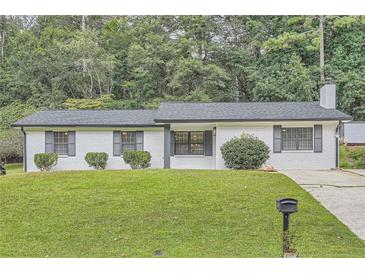 Charming, renovated brick ranch with stylish shutters and lush green lawn at 2714 Preston Dr, Decatur, GA 30034