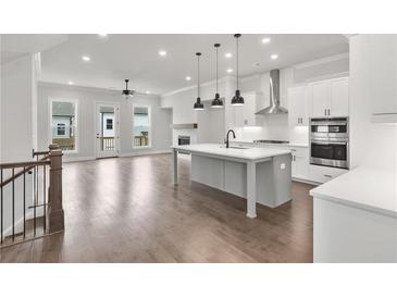 Modern kitchen with large island, stainless steel appliances, and an open floor plan at 171 Basil Street Dr, Cumming, GA 30040