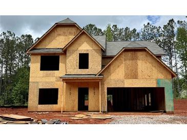Exterior view of new construction home with wood sheathing and open garage at 484 Charleston Pl, Villa Rica, GA 30180