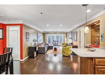 Bright living room featuring hardwood floors and access to a patio via sliding glass doors at 3201 Lenox Ne Rd # 22, Atlanta, GA 30324