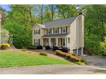 Beautiful two-story home with a manicured lawn, tasteful landscaping, and a charming front porch at 480 Springs End Ne Ln, Marietta, GA 30068