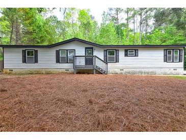 Charming single story home with light siding, dark shutters and trim, and inviting front porch at 350 White Birch Dr, Covington, GA 30016