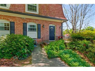 Charming brick townhouse with a well-maintained front yard and black door at 1261 Lavista Ne Rd # J-4, Atlanta, GA 30324