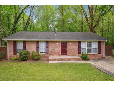 Charming single-story brick home featuring a well-maintained lawn and inviting curb appeal at 2962 Invermere Woods Ct, Lithonia, GA 30038