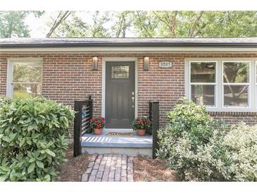Charming brick home entrance with a decorative front door, brick path and lush landscaping at 3207 Canary Ct, Decatur, GA 30032
