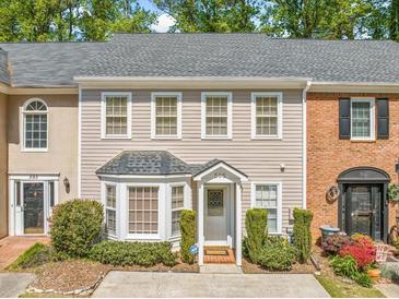 Charming townhouse with a well-manicured front yard and classic architectural details at 595 Saint James Se Walk, Marietta, GA 30067