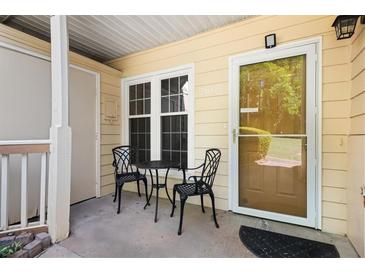Inviting front porch with table and chairs, perfect for relaxing outdoors at 2605 Vineyard Se Way, Smyrna, GA 30082