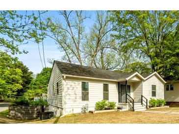 Charming home exterior with mature trees, lush greenery, and inviting curb appeal at 3143 Church St, East Point, GA 30344