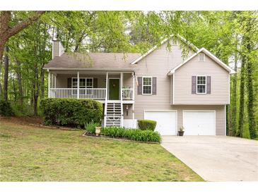 Charming two-story home with a cozy front porch and well-manicured landscaping at 69 Due West Pass, Dallas, GA 30157