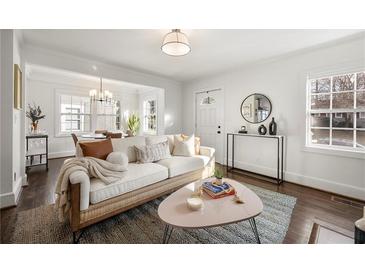 Bright living room with white walls, hardwood floors, neutral sofa, and floods of natural light at 1612 Alder Se Ct, Atlanta, GA 30317