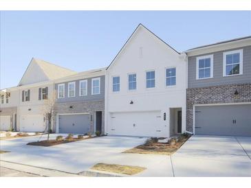 Modern townhome exterior showcases a two-car garage and neutral color palette at 170 Bluffington Way, Marietta, GA 30066