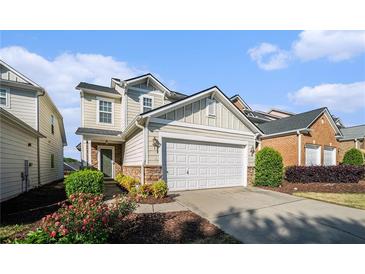 Charming two-story home with a two-car garage, stone accents, and landscaped front yard at 2206 Palomino Ln, Conyers, GA 30012