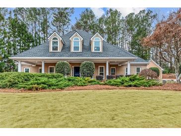 Charming home featuring a well-manicured lawn, covered porch, and dormer windows at 2407 Honey Ct, Mcdonough, GA 30252