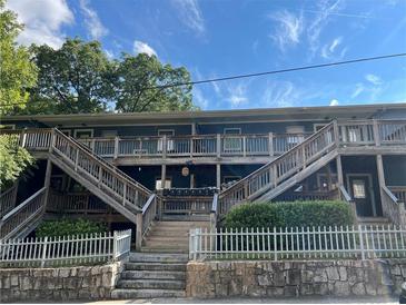 Attractive apartment complex with wooden stairs and white picket fence around a stone base at 562 Formwalt Sw St # 4, Atlanta, GA 30312