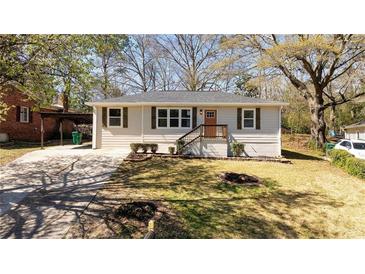 Charming single-story home featuring a well-maintained lawn and inviting front porch with classic curb appeal at 2215 Gordon Se Cir, Smyrna, GA 30080