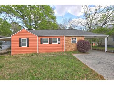 Charming home with a single carport, manicured lawn and cozy curb appeal at 5164 Phillips Dr, Forest Park, GA 30297