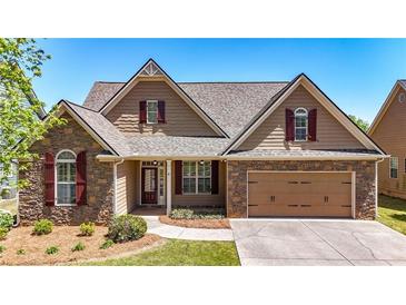 Charming home featuring stone accents, a two-car garage, well-manicured lawn, and a welcoming entrance at 28 Summer Nw Pl, Cartersville, GA 30121