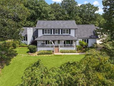 Charming two-story home with a welcoming front porch and well-manicured lawn at 269 Red Gate Dr, Canton, GA 30115