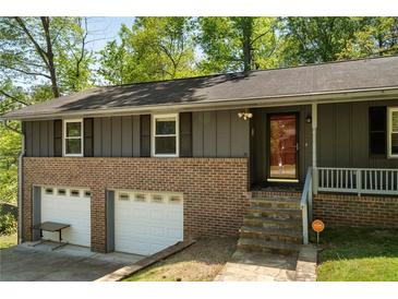 Charming two-story home featuring a brick facade and two-car garage at 3105 Sumac Dr, Atlanta, GA 30360