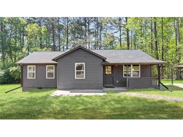 Charming single-story home with a well-maintained lawn and inviting covered front porch at 3917 Dallas Acworth Nw Hwy, Acworth, GA 30101